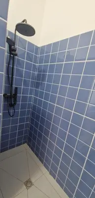 a blue tiled bathroom with a shower at Casa Cesaria Guest House in Sal Rei