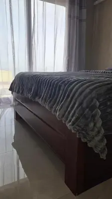 a bed sitting in a room with a window at Ocean View Studio 1 in Mindelo