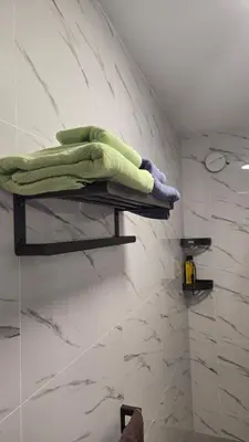 a bathroom with two shelves with towels on them at Ocean View Studio 1 in Mindelo