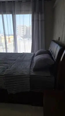 a bed sitting in front of a window with a view at Ocean View Studio 1 in Mindelo