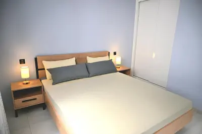 a bedroom with a large bed with two night stands at Nature Breeze in Sal Rei