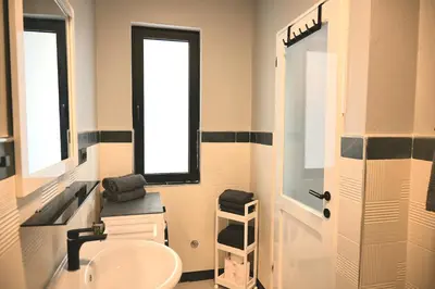 a bathroom with a sink and a toilet and a window at Nature Breeze in Sal Rei