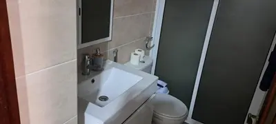 a bathroom with a white sink and a toilet at Casa Flor Apartment in Ribeira Grande