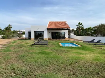 a house with a swimming pool in a yard at Casa de Cabo Verde in Santa Maria