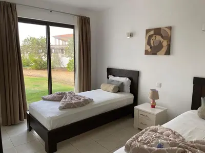 two beds in a room with a window at Casa de Cabo Verde in Santa Maria