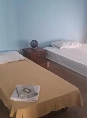 two beds in a room with a towel on the bed at kaza sz in Praia