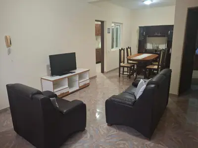 a living room with two chairs and a television at kaza sz in Praia