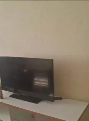 a flat screen tv sitting on top of a table at kaza sz in Praia
