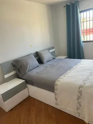 a bedroom with a bed and a window at Morabeza Lodge in Mindelo