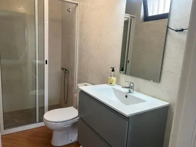 a bathroom with a sink and a toilet and a shower at Morabeza Lodge in Mindelo