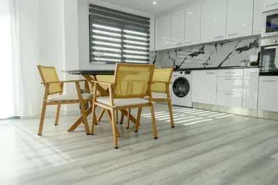 a dining room with a table and chairs in a kitchen at Edifício Yes, Luxury 2 Bed Apartments, Praia, Cape Verde with Balcony and AC in Praia