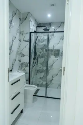 a bathroom with a shower and a toilet at Edifício Yes, Luxury 2 Bed Apartments, Praia, Cape Verde with Balcony and AC in Praia
