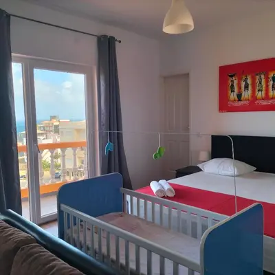 a bedroom with a bed and a window and a couch at Hotel Miranda & Miranda in Ponta do Sol