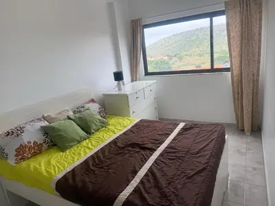 a bedroom with a bed with a large window at Single & double Room for women only & Breakfast in Praia