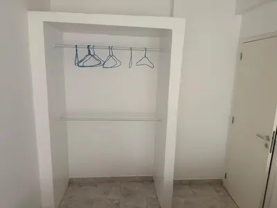a white closet with three pairs of glasses on a rack at Single & double Room for women only & Breakfast in Praia