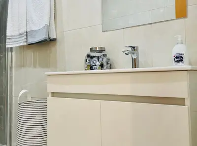 a white bathroom with a sink and a mirror at Sal Little Heart Sun NEW Apartment 5 in Santa Maria