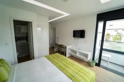 a bedroom with a bed and a desk and a window at GREEN STUDIO TARRAFAL - Ap 02 in Prainha
