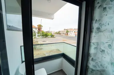 a window with a view of a street at GREEN STUDIO TARRAFAL - Ap 02 in Prainha
