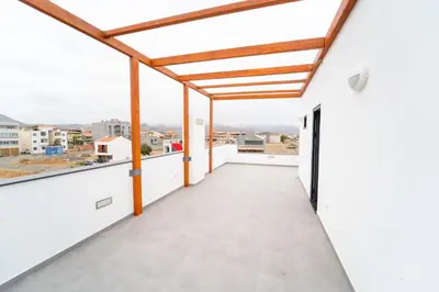an empty balcony with a view of the city at GREEN STUDIO TARRAFAL - Ap 02 in Prainha