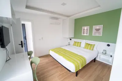 a bedroom with a bed with yellow and green walls at GREEN STUDIO TARRAFAL - Ap 01 in Prainha