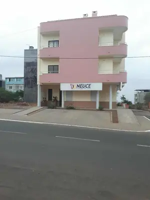 a large pink building with a x middle sign on it at Avenida NHU SANTIAGO in Santa Cruz