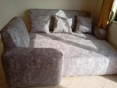 a couch and a chair in a room at Avenida NHU SANTIAGO in Santa Cruz