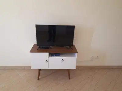 a tv sitting on top of a white dresser at Avenida NHU SANTIAGO in Santa Cruz
