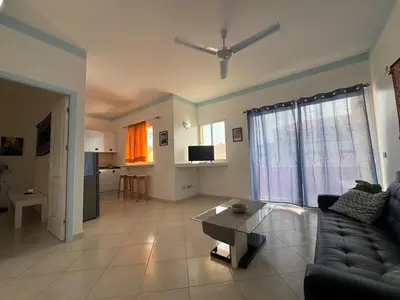 a living room with a couch and a table at Holiday Properties Ocean Breeze in Santa Maria