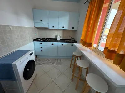 a kitchen with a washing machine in a kitchen at Holiday Properties Ocean Breeze in Santa Maria