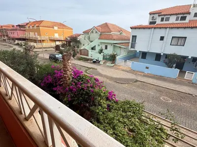 a view of a street from a balcony with flowers at Holiday Properties Ocean Breeze in Santa Maria