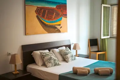 a bedroom with a bed with a painting on the wall at Orange by No Stress ACWifi in Santa Maria