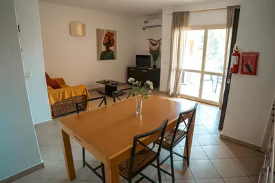 a living room with a wooden table and chairs at Orange by No Stress ACWifi in Santa Maria