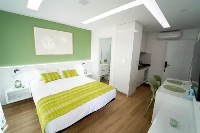 a bedroom with a bed and a green wall at GREEN STUDIO TARRAFAL - Ap 03 in Tarrafal