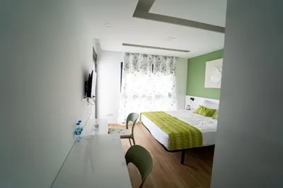 a small bedroom with a bed and a window at GREEN STUDIO TARRAFAL - Ap 03 in Tarrafal