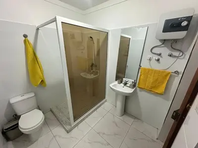 a bathroom with a shower and a toilet and a sink at Kasa Kutxa in Tarrafal