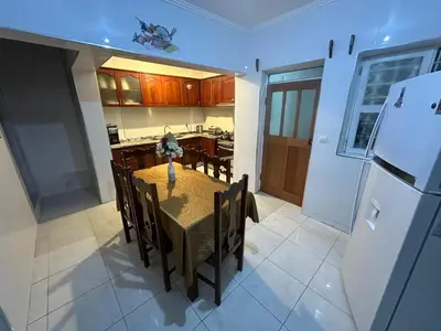 a kitchen and dining room with a table and a refrigerator at Kasa Kutxa in Tarrafal