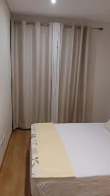 a bedroom with white curtains and a bed in it at Clara's Place - Faia Suite in Praia