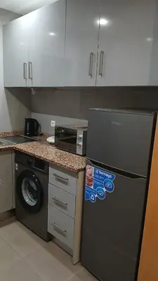 a kitchen with a refrigerator and a washing machine at Clara's Place - Faia Suite in Praia