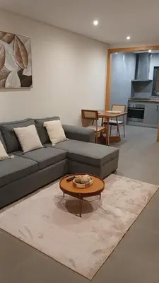 a living room with a couch and a coffee table at Clara's Place - Faia Suite in Praia