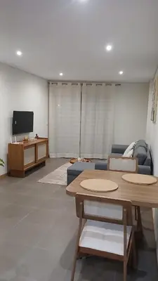 a living room with a table and a couch at Clara's Place - Faia Suite in Praia
