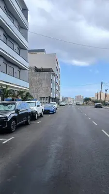 a parking lot with cars parked on the side of a street at Clara's Place - Faia Suite in Praia