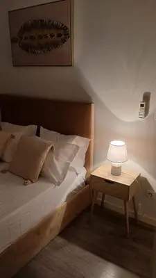 a bedroom with a bed and a table with a lamp at Clara's Place - Morabeza Suite in Praia