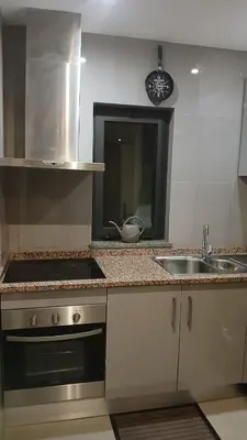 a kitchen with a sink and a counter top at Clara's Place - Morabeza Suite in Praia