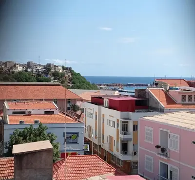 a view of a city with buildings and the ocean at Four Palms Guest House in Praia