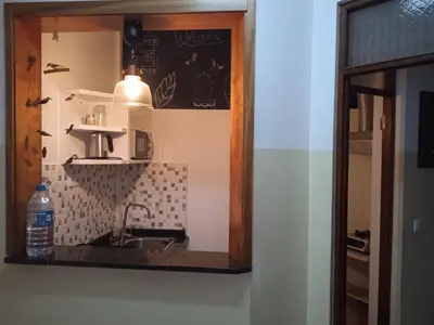 a small kitchen with a sink and a mirror at Mindelo Tamba in Mindelo