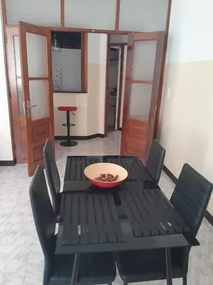 a black table with chairs and a bowl on it at Mindelo Tamba in Mindelo