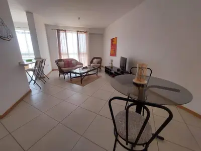 a living room with a glass table and chairs at SweetLar in Praia