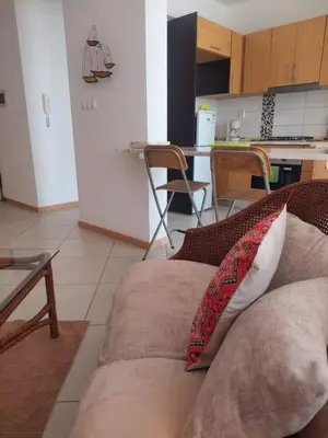 a living room with a couch and a kitchen at SweetLar in Praia