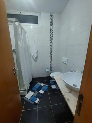 a bathroom with a sink and a toilet and a tub at SweetLar in Praia