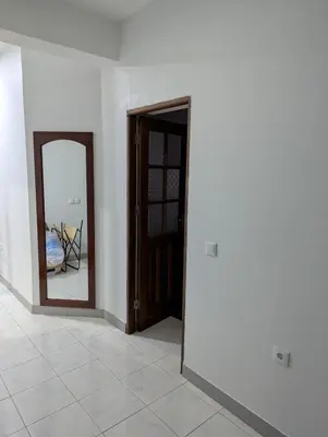 an empty room with a door and a mirror at Cozy 3 Bdr at Praia Da Laginha in Mindelo